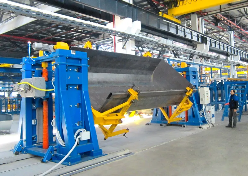 Headstock and tailstock positioners for welding body of a dump truck